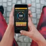 Runner using healthcare technology app on her smartphone