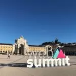 Web Summit sign in front of the Arco da Rua Augusta in Lisbon, Portugal
