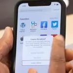 Someone holding an iPhone and enabling dictation on the screen, for accessibility testing