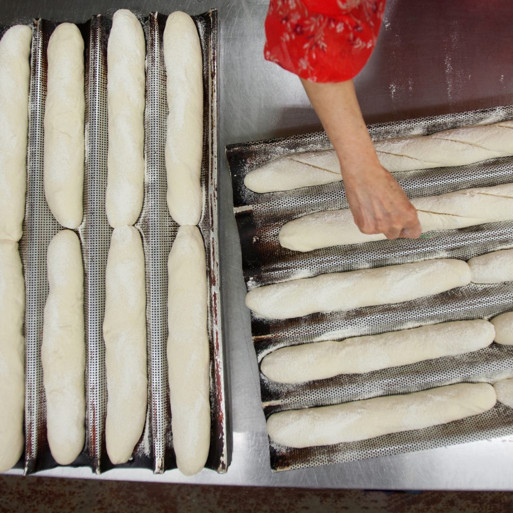 woman making fresh baguettes and breaking biases, IWD